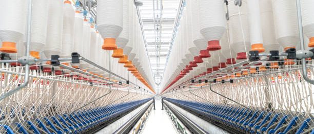 Spools of yarn on a spinning machine seen at the wool manufacturing facility